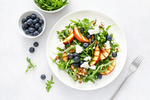 Peach, Blueberry And Arugula Fresh Fruit Salad With Cheese And Almond Nuts, Top View