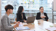 © Prathankarnpap - Senior older female executive ceo and young employee discuss corporate project at boardroom