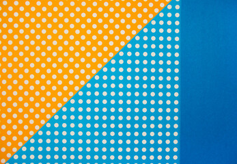 The paper is blue and orange. Various geometric shapes. White circles. Abstract background and texture.