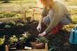 © cherryandbees - woman gardening herbs in her garden
