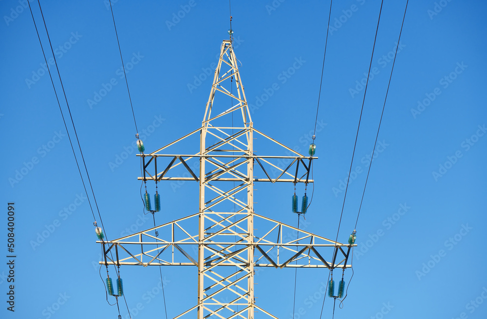 High voltage electricity tower with power line against blue sky ...