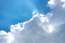 Blue Sky And Sunlight Penetrating Through The Clouds. Partly Cloudy Weather Concept.