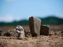 Photo Of Small Stones Placed On The Beach Resembling Small Menhirs.