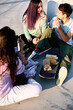 © chika_milan - Teenagers sits outdoors, escaping classes and eating fast food at railroad station.