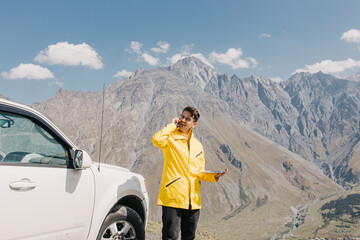 Traveler with a backpack talking on the phone. Adventure and hiking. Distant work