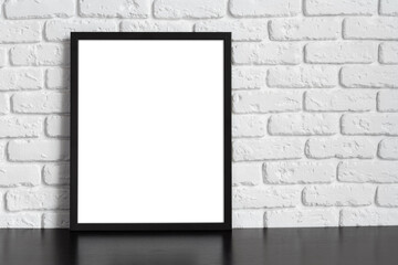 Wall Mural - Blank picture frame against brick wall with copy space