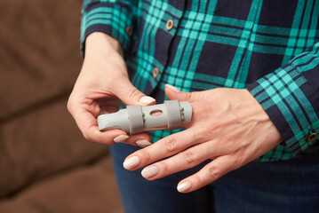 Orthosis on the finger of a female hand