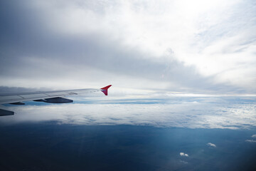 Wall Mural - aircraft wing above beautiful clouds and blue sky