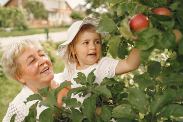 Wall Mural - Grandmother and granddaughter enjoyed in the garden