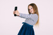 © F8  \ Suport Ukraine - Portrait of an excited little girl taking a selfie isolated on white background