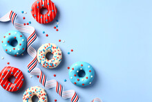 Happy Fourth Of July, USA Independence Day. 4th Of July Greeting Card Template With Donuts In Colors Of American Flag And Striped Ribbon On Blue Background.