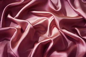 Wall Mural - Pink silk satin. Shiny fabric surface. Wavy folds. Beautiful background with space for design.