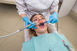 © Tania - A young female dentist fills a patient's tooth. Visiting an orthodontist.