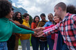 © Ivan - Group of ethnically diverse young people joining hands