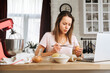 © KEA - Woman cooking  dessert at home and watches recipe video and tutorial on laptop. Egg lemon and  flour on the table. the process of making  cake, pancakes or meringue  for breakfast.