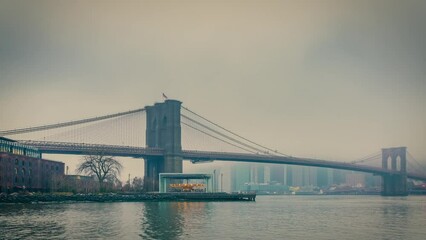 Fototapete - Timelapse of Brooklyn bridge at foggy morning, New York City. Zoom in effect