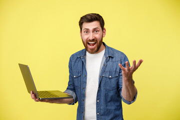 Wall Mural - Emotional man holding a laptop and shouting actively gesturing with his hands