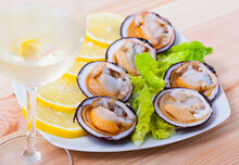 Raw Bivalve Mollusks (European Bittersweet) Served With Lemon On Plate
