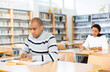 © JackF - Adult male student working in library, concept of adult education