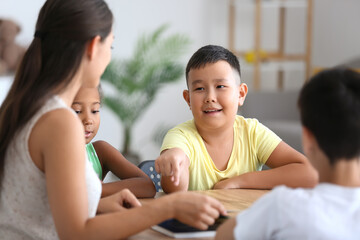 Poster - Little Asian boy having literature lesson in classroom