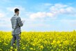 © BillionPhotos.com - Farmer business man in colza rapeseed field, with digital tablet computer. Agricultural concept. Harvest in field in summer.