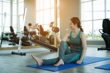 Asian Healthy Woman Doing Sport And Yoga In The Fitness Room. 