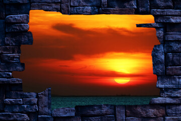 Wall Mural - sunset back blur red cloud on the night sky over the horizon sea in hole stone wal