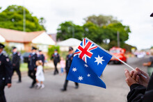 Hands Of Old Man Holding Flag Watching ANZAC Day Parade