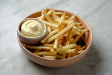 Close Up Shot  Of French Fries With Mayonnaise In A Pink Bowl