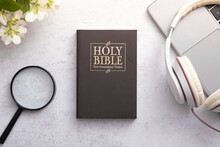 Top View Of Holy Bible On Working Table With Headphones. Bible Study And Search Online Concept