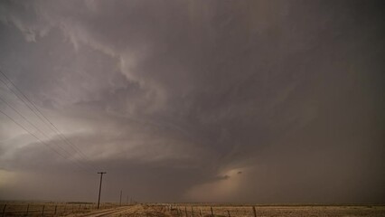 Wall Mural - Lightning bolt striking the ground as tornado touches down in the distance near Morton Texas.