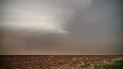 Wall Mural - Lightning flashes as supercell storm moves through dusty landscape in Texas.