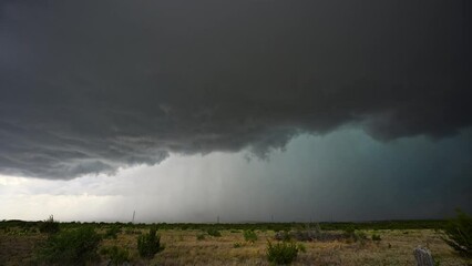 Wall Mural - Supercell thunderstorm rolling over the landscape viewing hail core in Texas.