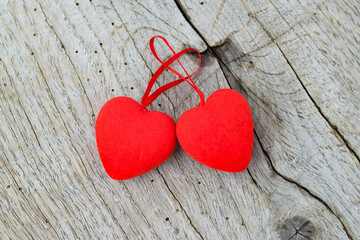 Two red hearts on a wooden background, copy space. Concept of valentine's day and falling in love