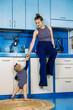© irissca - Little girl helps mom in the kitchen. Household chores, housekeeping for parents