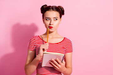 Poster - Portrait of minded intelligent girl hold pencil look empty space contemplate isolated on pink color background