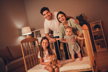 Wall Mural - Photo of cheerful sweet mother father little children having fun late night indoors room home house