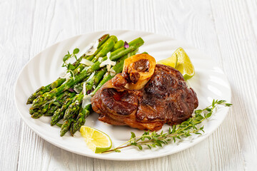 Wall Mural - braised osso buco with grilled asparagus, top view