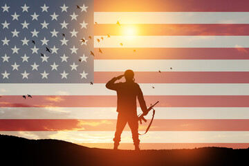 USA army soldier saluting on a background of USA flag. Greeting card for Veterans Day, Memorial Day, Independence Day.