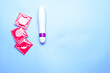 female dildo and condoms for sex shot from above on a light blue background horizontally