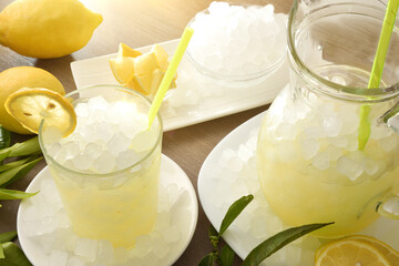 Wall Mural - Lemon drink with ice on table and white isolated background