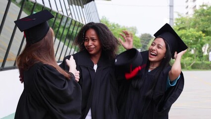 Wall Mural - Dancing graduate woman student. Cheerful young beautiful teenage in graduation tiktok dancing at college. Black and asian people.