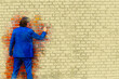 © wernerimages - man in blue suit standing at brick wall with paintbrush in watercolors style