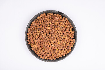 chickpeas (Bengal Gram) in rock bowl on white background. Close up of Organic chana or chickpea (Cicer arietinum). for design and banner. top view chickpeas.