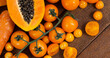 Image of fresh organic vegan food with orange vegetables on wooden board