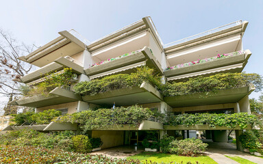 Exterior of a modern apartment building with pilotis and extended balconies, Athens, Greece.