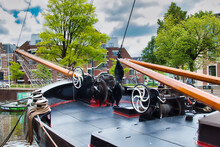 The Bow Of A Traditional Dutch Sailing Barge, With Anchor Winch And Mast Winch, In The Harbour Of Leeuwarden, The Netherlands
