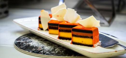 Wall Mural - Souffle cake decorated with marshmallow in small pieces on a plate close-up