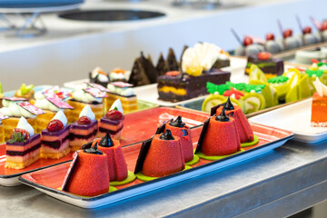 Wall Mural - Beautiful and bright photo of pastries and cakes on the bar counter in the hotel