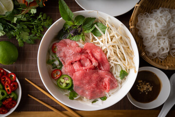 Wall Mural - authentic vietnamese pho rice noodle with raw beef